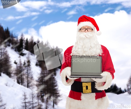 Image of man in costume of santa claus with laptop