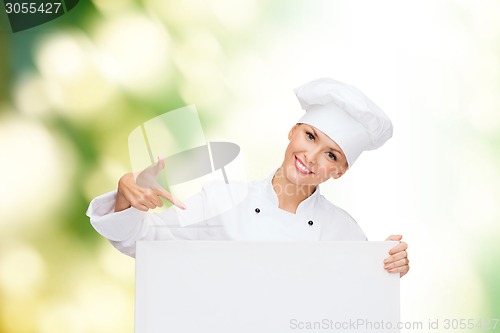 Image of smiling female chef with white blank board