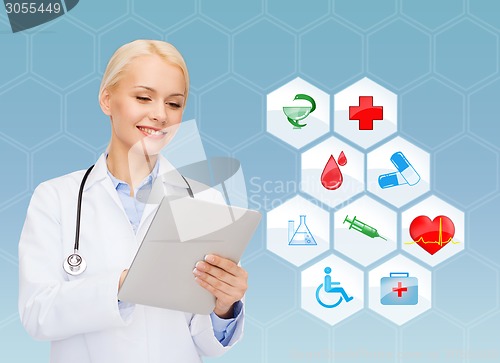 Image of smiling doctor with tablet pc and medical symbols