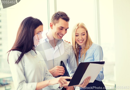 Image of business team looking at clipboard