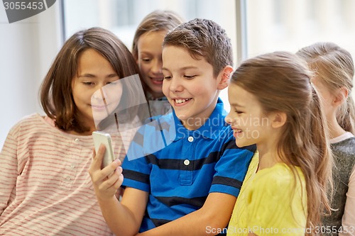 Image of group of school kids taking selfie with smartphone