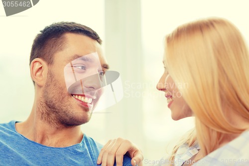 Image of smiling happy couple at home