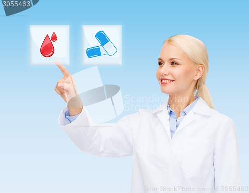 Image of smiling doctor or nurse pointing to pills icon