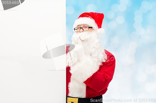Image of man in costume of santa claus with billboard