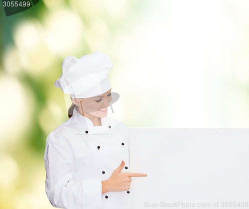 Image of smiling female chef with white blank board