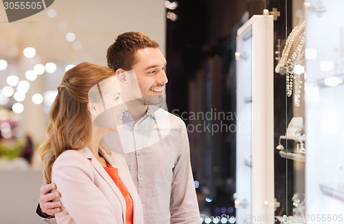 Image of couple looking to shopping window at jewelry store