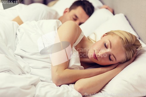 Image of happy couple sleeping in bed