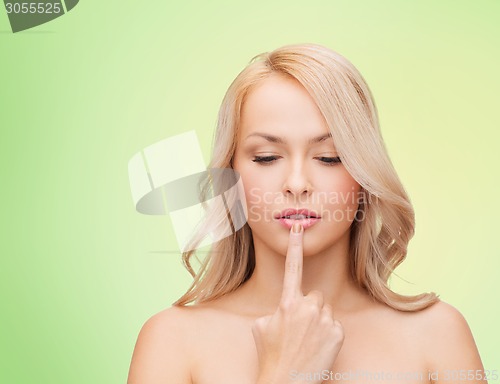 Image of beutiful young woman touching her lips