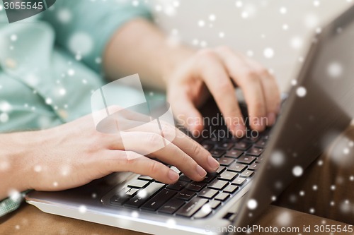 Image of close up of man working with laptop at home