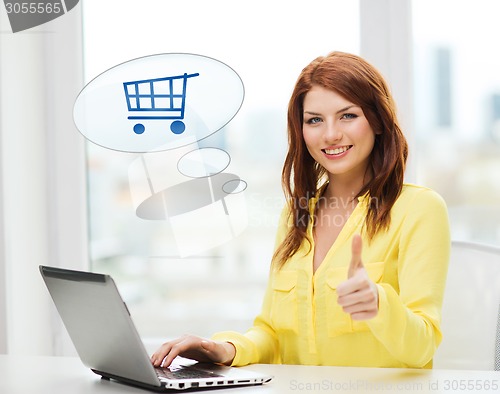 Image of smiling woman with laptop computer shopping online