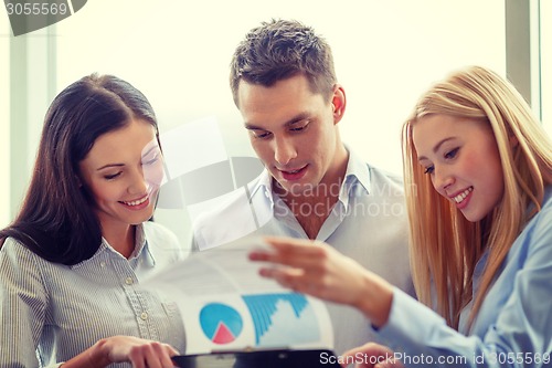 Image of business team looking at clipboard