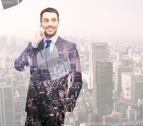 Image of smiling young businessman over city background