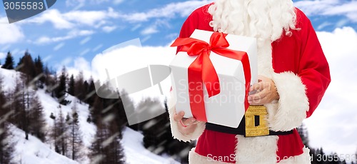 Image of man in costume of santa claus with gift box