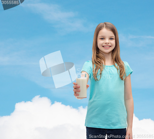 Image of smiling little girl giving glass of milk