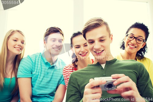 Image of smiling students with digital camera at school