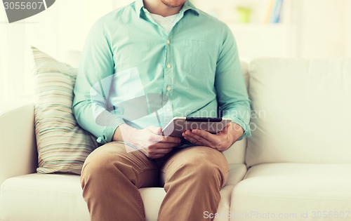 Image of close up of man with tablet pc computer at home