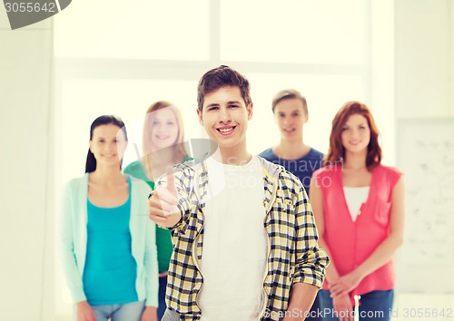 Image of male student with classmates showing thumbs up