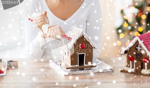 Image of close up of woman making gingerbread houses