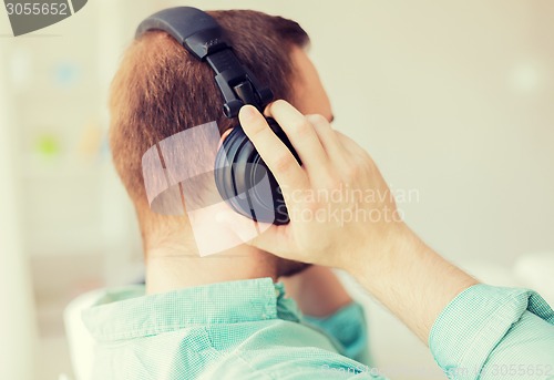 Image of close up of man in headphones at home