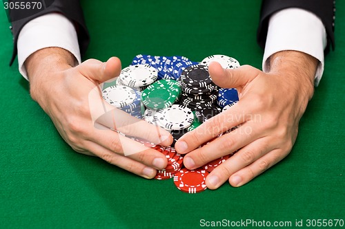 Image of poker player with chips at casino table
