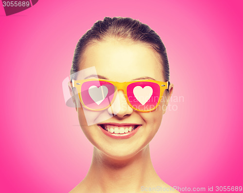 Image of smiling teenage girl in pink sunglasses