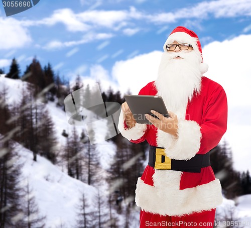 Image of man in costume of santa claus with tablet pc