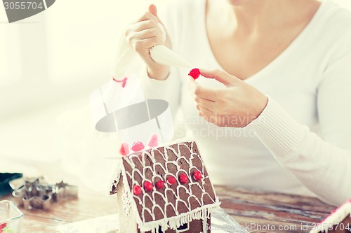 Image of close up of woman making gingerbread houses