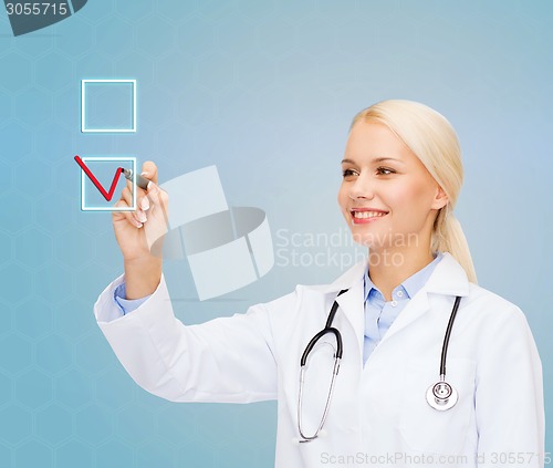 Image of female doctor drawing mark to check box