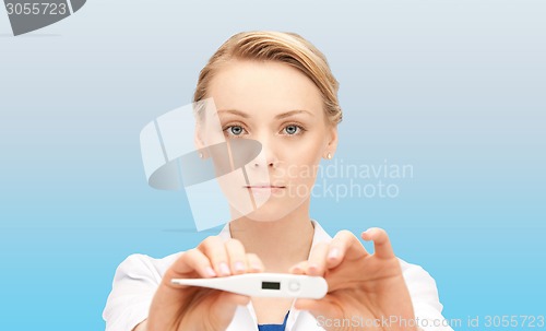 Image of young female doctor showing thermometer
