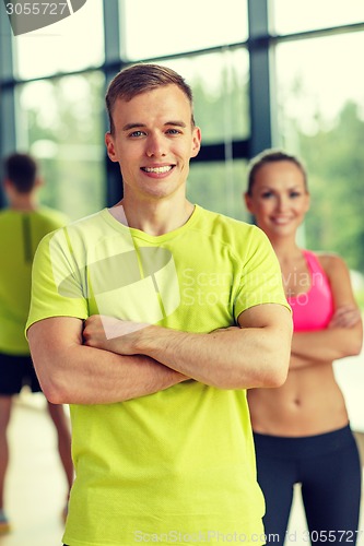 Image of smiling man and woman in gym