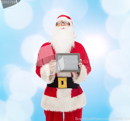 Image of man in costume of santa claus with tablet pc