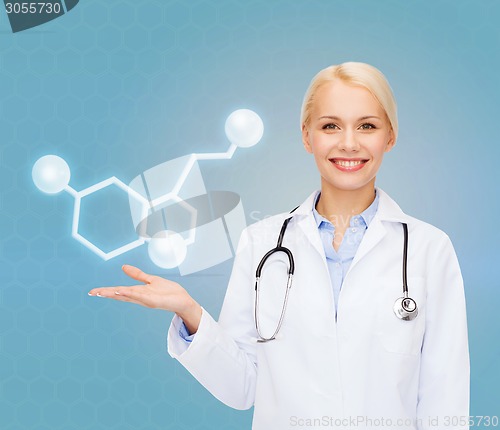 Image of smiling female doctor pointing to molecule