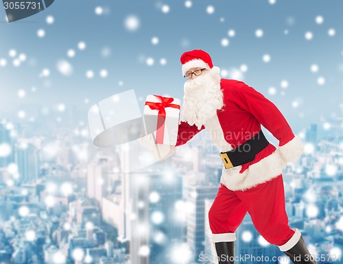 Image of man in costume of santa claus with gift box