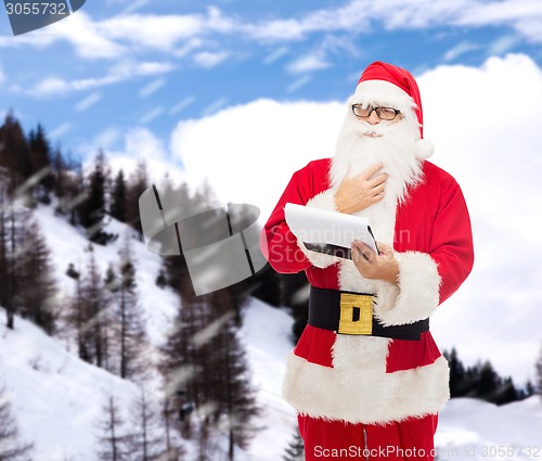 Image of man in costume of santa claus with notepad