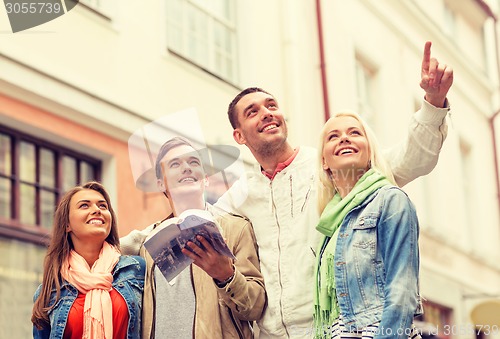 Image of group of friends with city guide exploring town