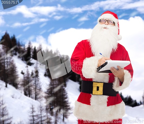 Image of man in costume of santa claus with notepad