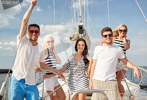 Image of smiling friends sailing on yacht