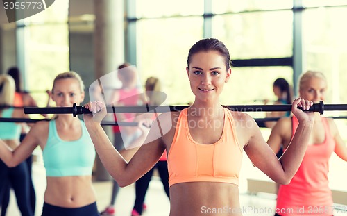 Image of group of women with bars in gym