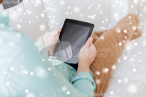 Image of close up of man with tablet pc computer at home