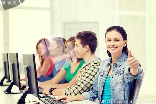 Image of female student with classmates in computer class