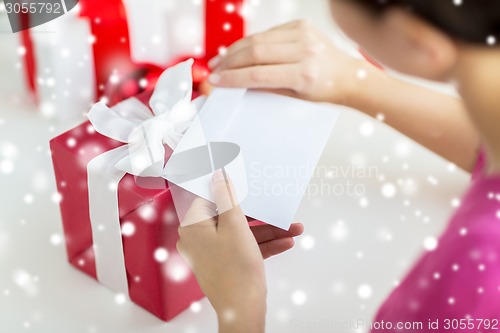 Image of close up of woman with letter and presents