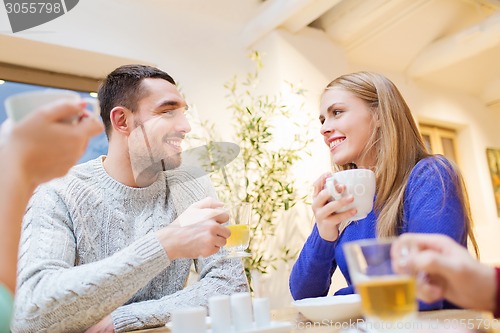Image of happy couple meeting and drinking tea or coffee
