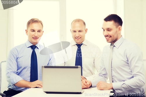 Image of business team working with laptop in office