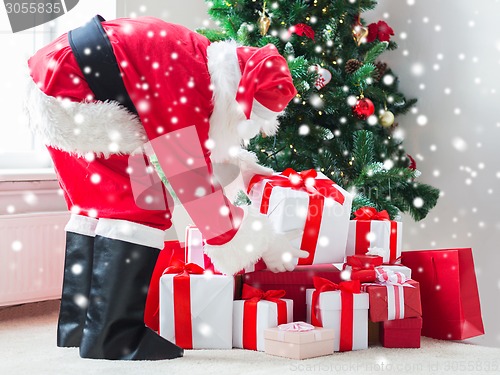 Image of man in costume of santa claus with presents