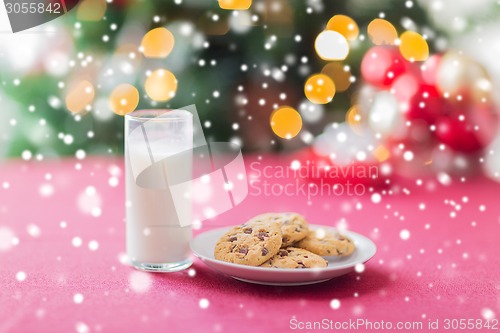 Image of close up of cookies and milk glass on table