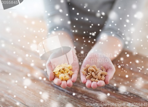 Image of female hands with different pasta variations