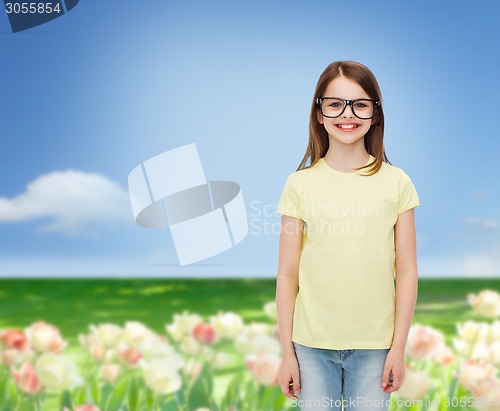 Image of smiling cute little girl in black eyeglasses