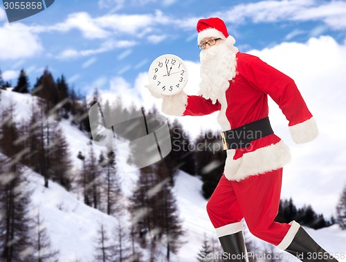 Image of man in costume of santa claus with clock