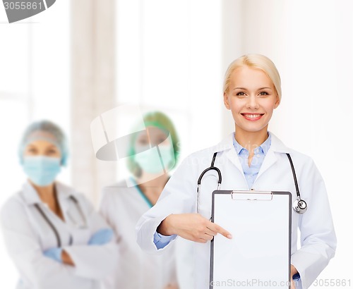 Image of smiling female doctor with clipboard