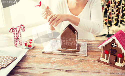 Image of close up of woman making gingerbread houses